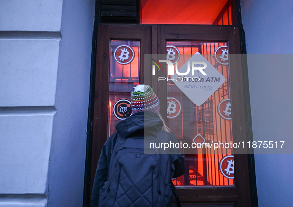 RZESZOW, POLAND - DECEMBER 16:
A woman checking the latest Bitcoin prices through the window of a Bitcoin ATM, on December 16, 2024, in Rzes...