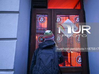 RZESZOW, POLAND - DECEMBER 16:
A woman checking the latest Bitcoin prices through the window of a Bitcoin ATM, on December 16, 2024, in Rzes...