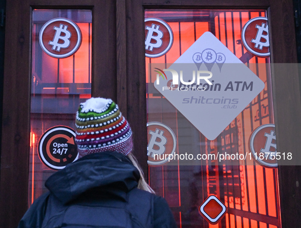 RZESZOW, POLAND - DECEMBER 16:
A woman checking the latest Bitcoin prices through the window of a Bitcoin ATM, on December 16, 2024, in Rzes...