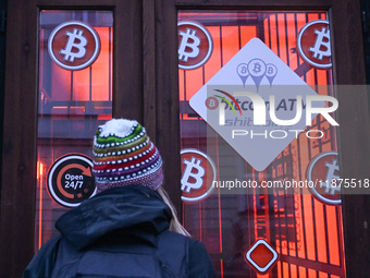 RZESZOW, POLAND - DECEMBER 16:
A woman checking the latest Bitcoin prices through the window of a Bitcoin ATM, on December 16, 2024, in Rzes...