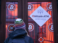 RZESZOW, POLAND - DECEMBER 16:
A woman checking the latest Bitcoin prices through the window of a Bitcoin ATM, on December 16, 2024, in Rzes...