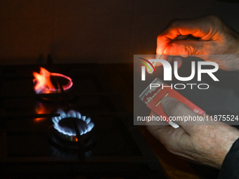 RZESZOW, POLAND - DECEMBER 16:
A person lights a match to ignite the natural gas burner of a natural-gas-burning stove, on December 16, 2024...