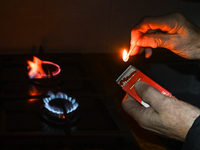 RZESZOW, POLAND - DECEMBER 16:
A person lights a match to ignite the natural gas burner of a natural-gas-burning stove, on December 16, 2024...