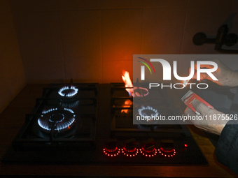 RZESZOW, POLAND - DECEMBER 16:
A person lights a match to ignite the natural gas burner of a natural-gas-burning stove, on December 16, 2024...