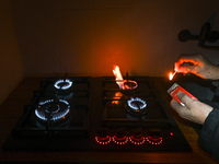 RZESZOW, POLAND - DECEMBER 16:
A person lights a match to ignite the natural gas burner of a natural-gas-burning stove, on December 16, 2024...