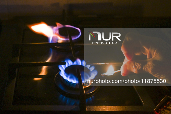 RZESZOW, POLAND - DECEMBER 16:
A person lights a match to ignite the natural gas burner of a natural-gas-burning stove, on December 16, 2024...