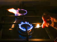 RZESZOW, POLAND - DECEMBER 16:
A person lights a match to ignite the natural gas burner of a natural-gas-burning stove, on December 16, 2024...