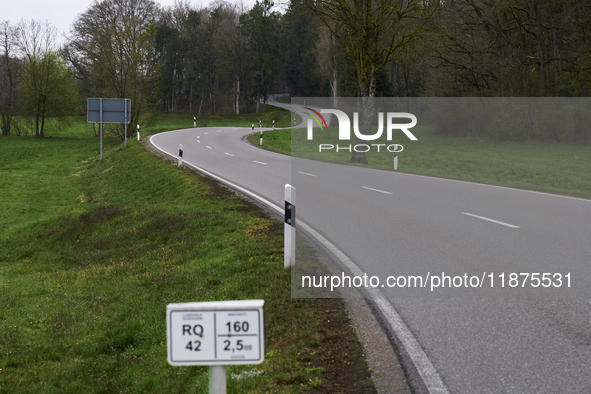 A winding asphalt road meanders through the lush green countryside in Dachau, Germany, on April 4, 2023. 