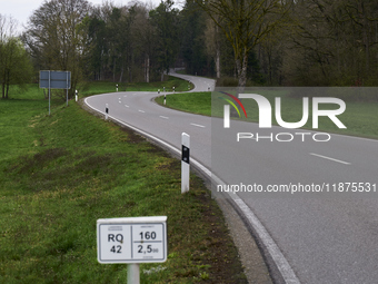 A winding asphalt road meanders through the lush green countryside in Dachau, Germany, on April 4, 2023. (