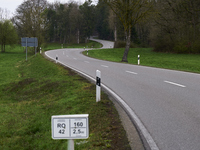 A winding asphalt road meanders through the lush green countryside in Dachau, Germany, on April 4, 2023. (