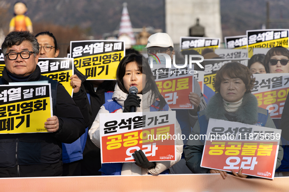 Healthcare and care workers hold a rally at Gwanghwamun Square in Seoul, South Korea, on December 17, 2024, calling for the strengthening of...