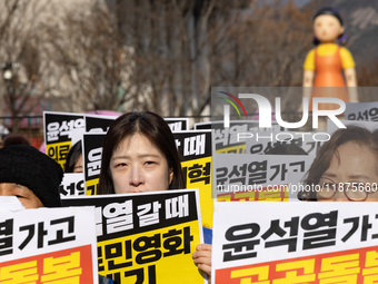 Healthcare and care workers hold a rally at Gwanghwamun Square in Seoul, South Korea, on December 17, 2024, calling for the strengthening of...