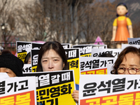 Healthcare and care workers hold a rally at Gwanghwamun Square in Seoul, South Korea, on December 17, 2024, calling for the strengthening of...