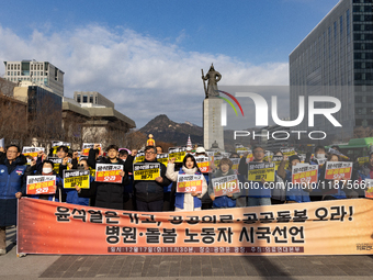 Healthcare and care workers hold a rally at Gwanghwamun Square in Seoul, South Korea, on December 17, 2024, calling for the strengthening of...