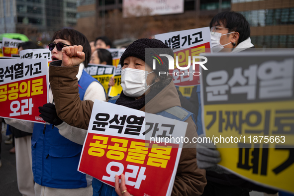 Healthcare and care workers hold a rally at Gwanghwamun Square in Seoul, South Korea, on December 17, 2024, calling for the strengthening of...