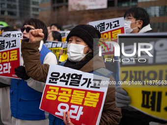 Healthcare and care workers hold a rally at Gwanghwamun Square in Seoul, South Korea, on December 17, 2024, calling for the strengthening of...