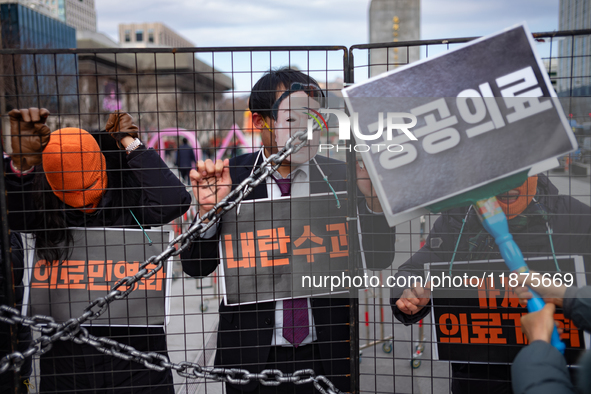 Officials from the Korean Health and Medical Workers' Union, under the Korean Confederation of Trade Unions Public Transport Workers' Union,...