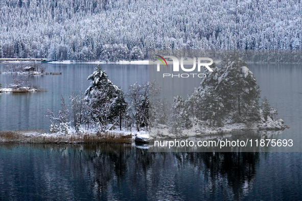 A small island is blanketed in snow at Lake Eibsee in Grainau, Bavaria, Germany, on December 13, 2024. The snow-covered island is surrounded...