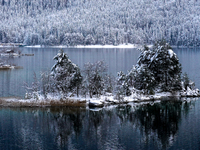 A small island is blanketed in snow at Lake Eibsee in Grainau, Bavaria, Germany, on December 13, 2024. The snow-covered island is surrounded...