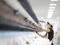 Villagers work at a production workshop of a textile company in Suqian, Jiangsu province, China, on December 16, 2024. (