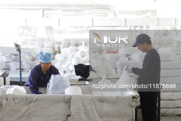 Villagers work at a production workshop of a textile company in Suqian, Jiangsu province, China, on December 16, 2024. 