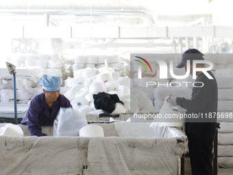 Villagers work at a production workshop of a textile company in Suqian, Jiangsu province, China, on December 16, 2024. (