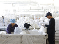 Villagers work at a production workshop of a textile company in Suqian, Jiangsu province, China, on December 16, 2024. (