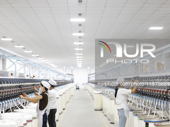 Villagers work at a production workshop of a textile company in Suqian, Jiangsu province, China, on December 16, 2024. (