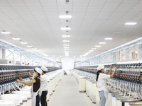 Villagers work at a production workshop of a textile company in Suqian, Jiangsu province, China, on December 16, 2024. (