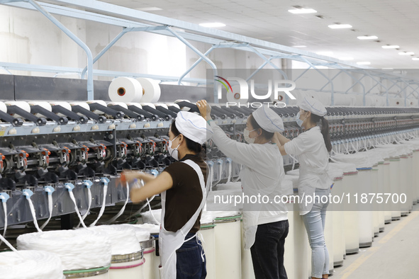 Villagers work at a production workshop of a textile company in Suqian, Jiangsu province, China, on December 16, 2024. 