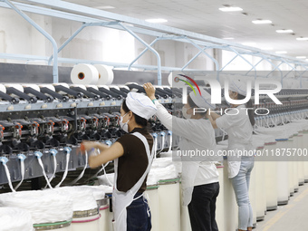 Villagers work at a production workshop of a textile company in Suqian, Jiangsu province, China, on December 16, 2024. (