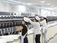 Villagers work at a production workshop of a textile company in Suqian, Jiangsu province, China, on December 16, 2024. (