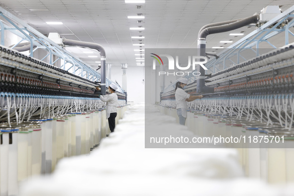 Villagers work at a production workshop of a textile company in Suqian, Jiangsu province, China, on December 16, 2024. 