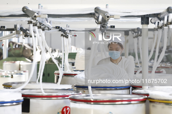 Villagers work at a production workshop of a textile company in Suqian, Jiangsu province, China, on December 16, 2024. 