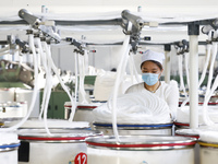 Villagers work at a production workshop of a textile company in Suqian, Jiangsu province, China, on December 16, 2024. (