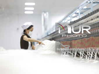 Villagers work at a production workshop of a textile company in Suqian, Jiangsu province, China, on December 16, 2024. (