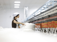 Villagers work at a production workshop of a textile company in Suqian, Jiangsu province, China, on December 16, 2024. (