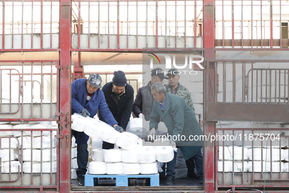 Villagers work at a production workshop of a textile company in Suqian, Jiangsu province, China, on December 16, 2024. 