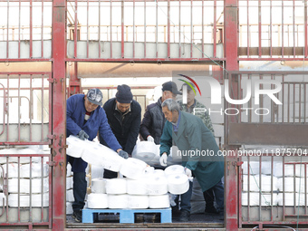 Villagers work at a production workshop of a textile company in Suqian, Jiangsu province, China, on December 16, 2024. (