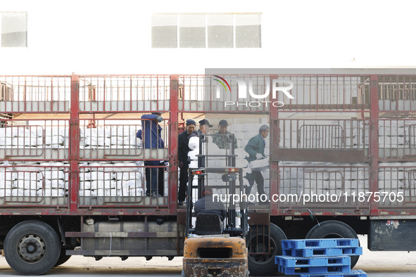 Villagers work at a production workshop of a textile company in Suqian, Jiangsu province, China, on December 16, 2024. 