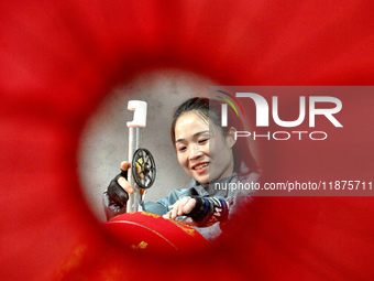 A worker makes red lanterns in Handan, China, on December 17, 2024. (