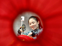 A worker makes red lanterns in Handan, China, on December 17, 2024. (