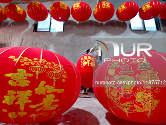 A worker makes red lanterns in Handan, China, on December 17, 2024. (