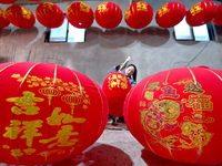 A worker makes red lanterns in Handan, China, on December 17, 2024. (