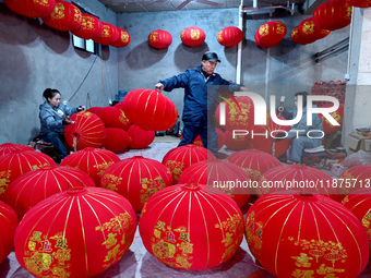 Workers make red lanterns in Handan, China, on December 17, 2024. (