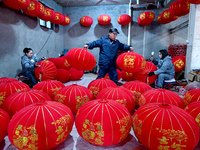 Workers make red lanterns in Handan, China, on December 17, 2024. (