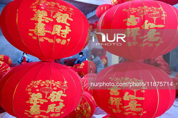 Workers make red lanterns in Handan, China, on December 17, 2024. 