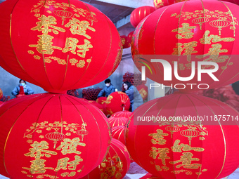 Workers make red lanterns in Handan, China, on December 17, 2024. (