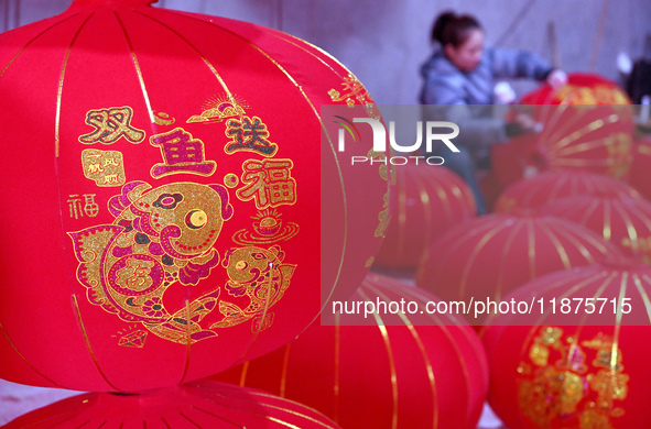 A worker makes red lanterns in Handan, China, on December 17, 2024. 