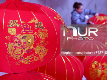 A worker makes red lanterns in Handan, China, on December 17, 2024. (